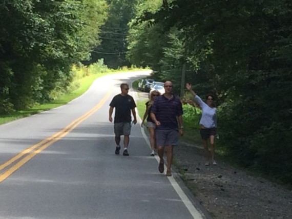 Middle aged group walking along country road