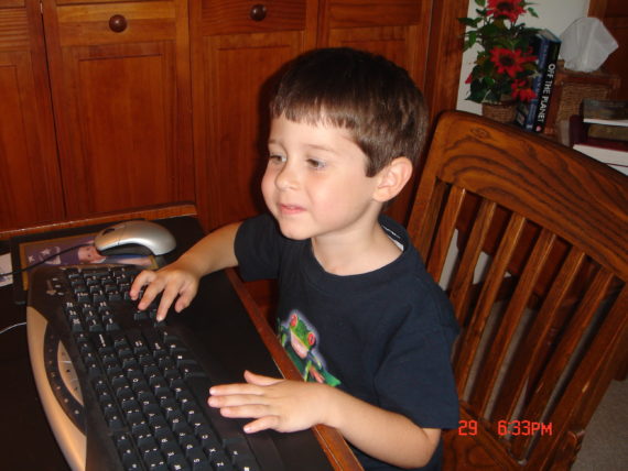 child at computer keyboard