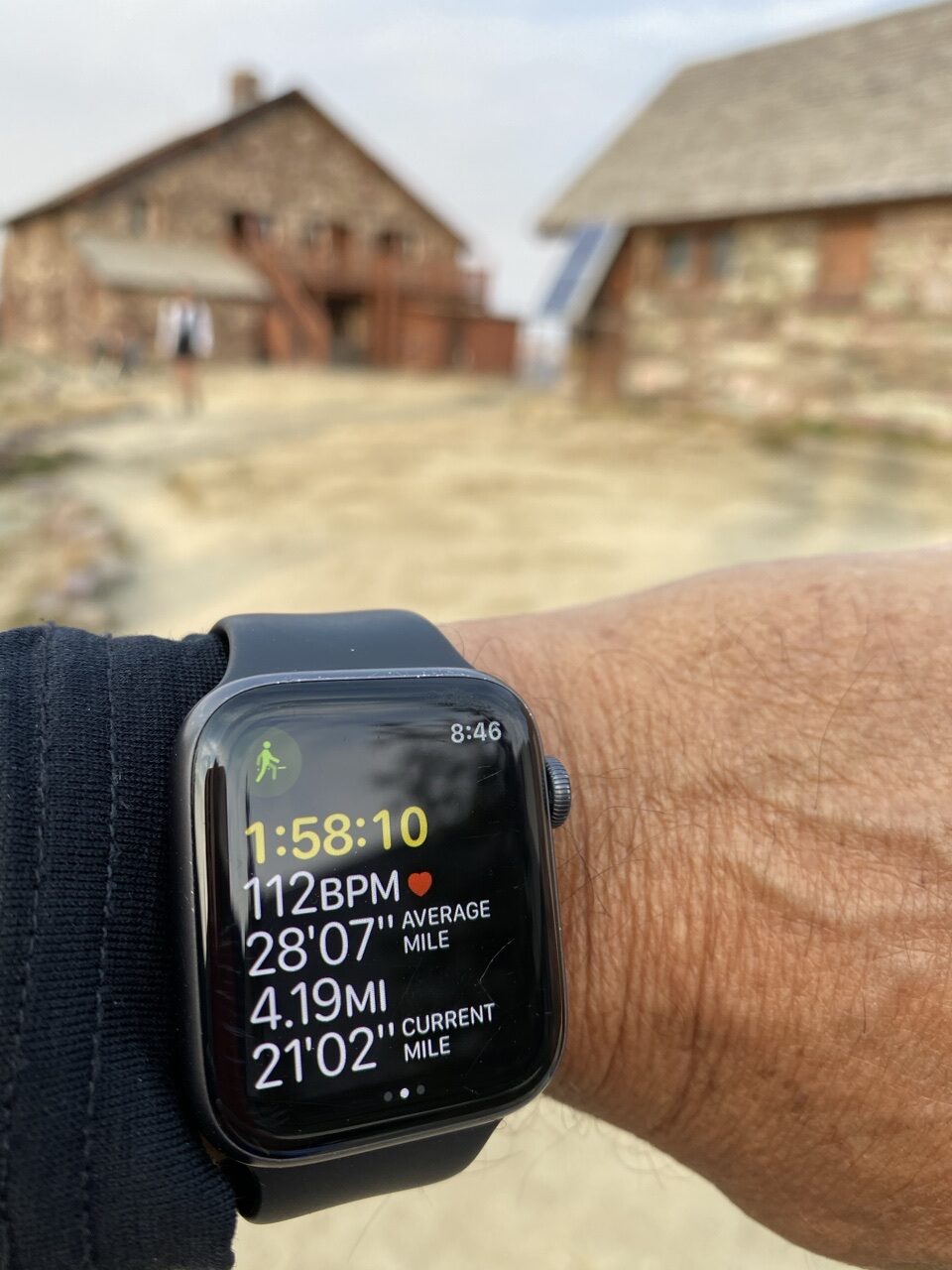 high mountain chalet blurred in background with foreground an Apple Watch screen