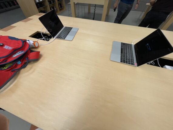 Two MacBooks on a large table