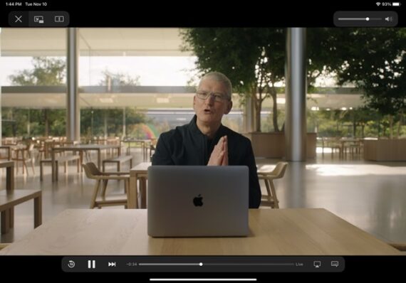 Tom Cook sitting at a desk with a MacBook