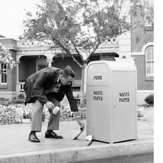 classic photo of Walt Disney picking up trash