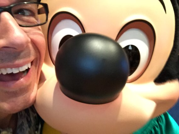 Close up of Mickey Mouse with a man next to him