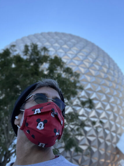 Man in a mask in front of spaceship Earth