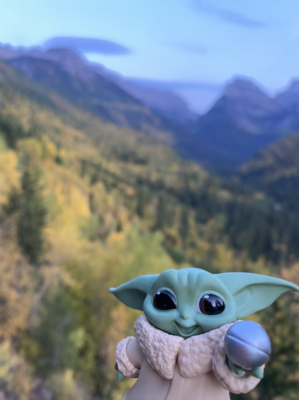 Baby Yoda toy in mountains