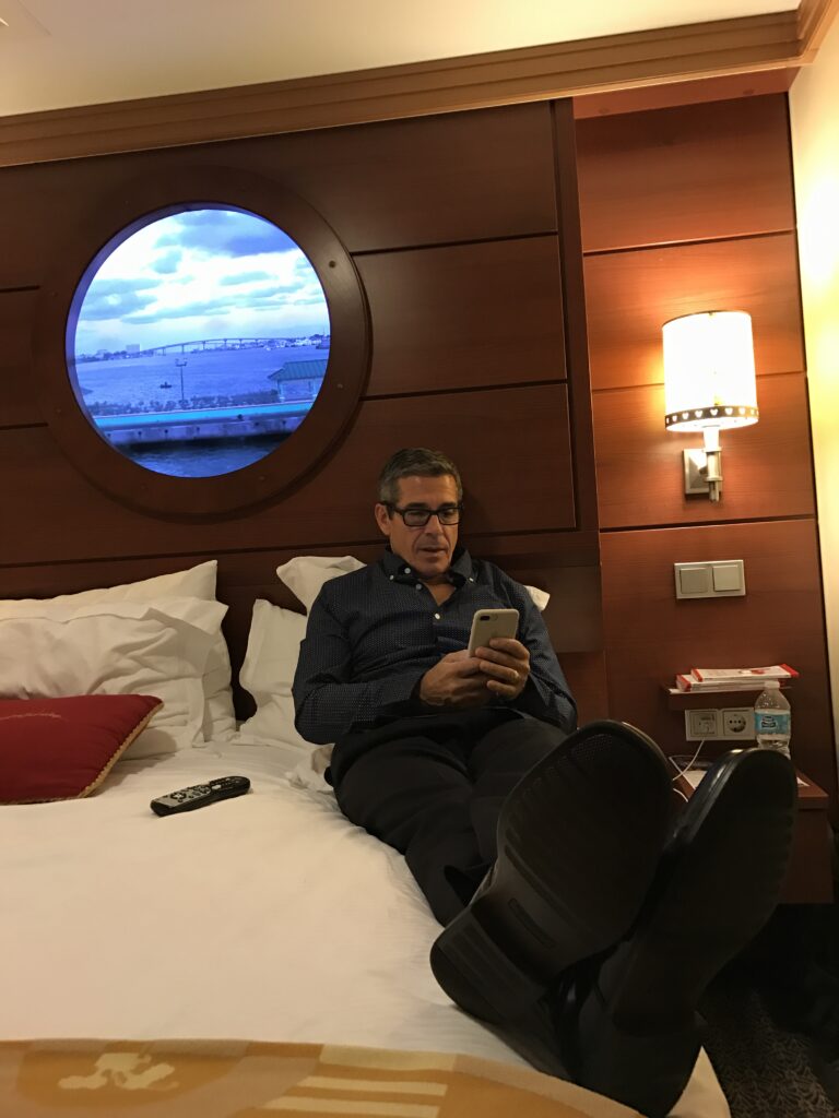 Disney business author Jeff Noel writing in Disney Cruise Ship stateroom