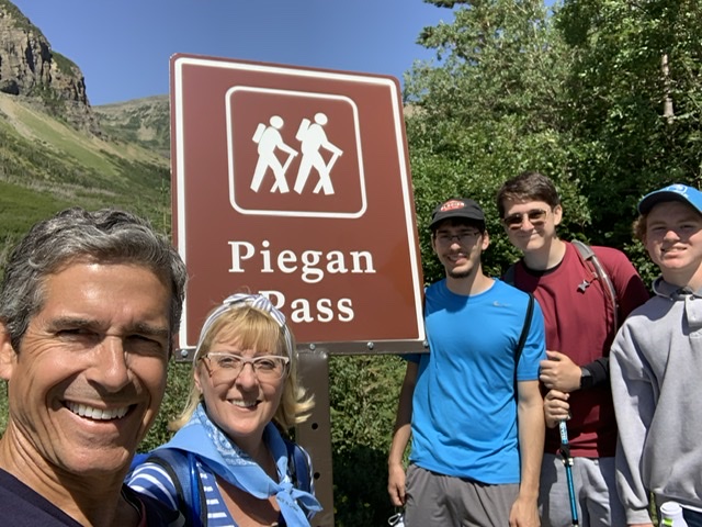 family at mountain trail entrance