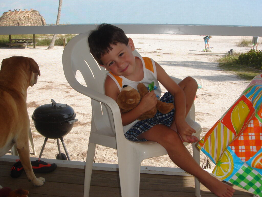 young boy at beach on a porch