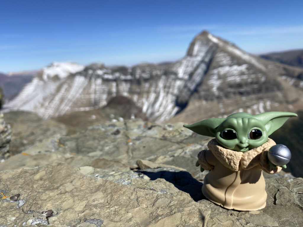 Disney Baby Yoda toy on mountain top