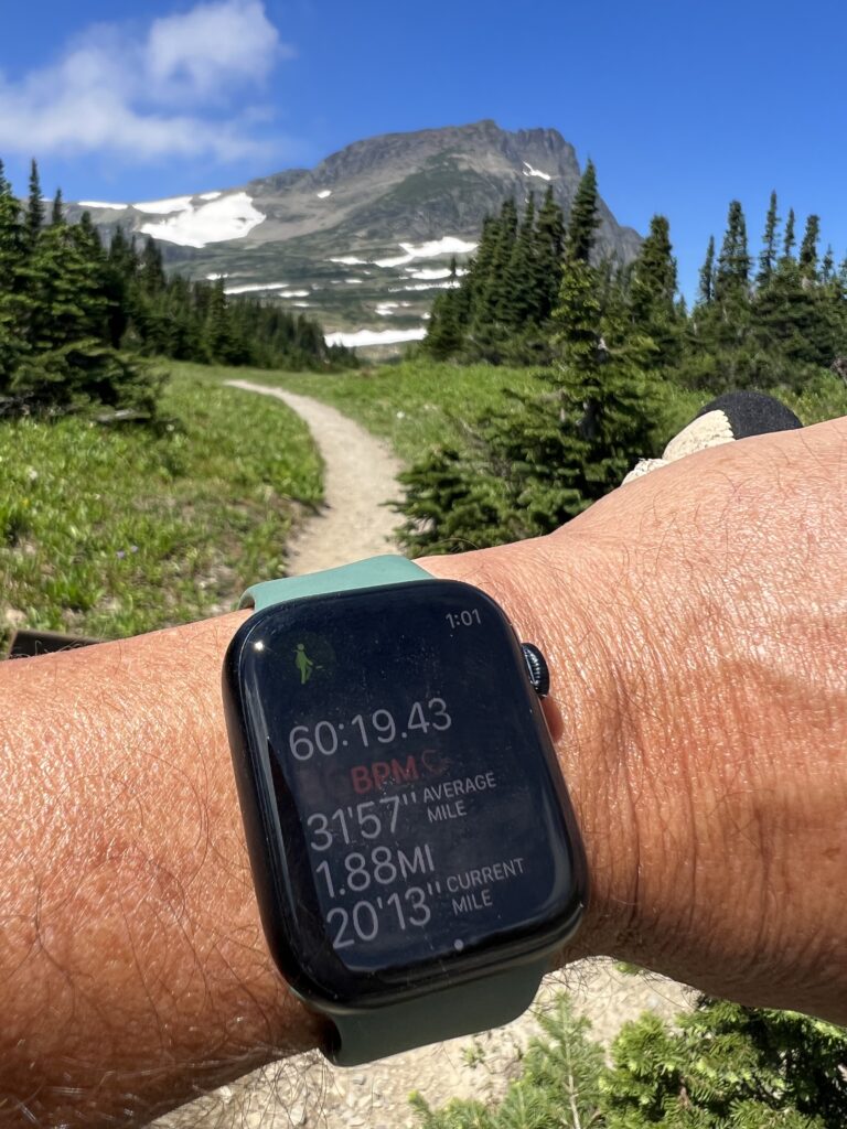 Apple Watch on a persons rest in the mountains