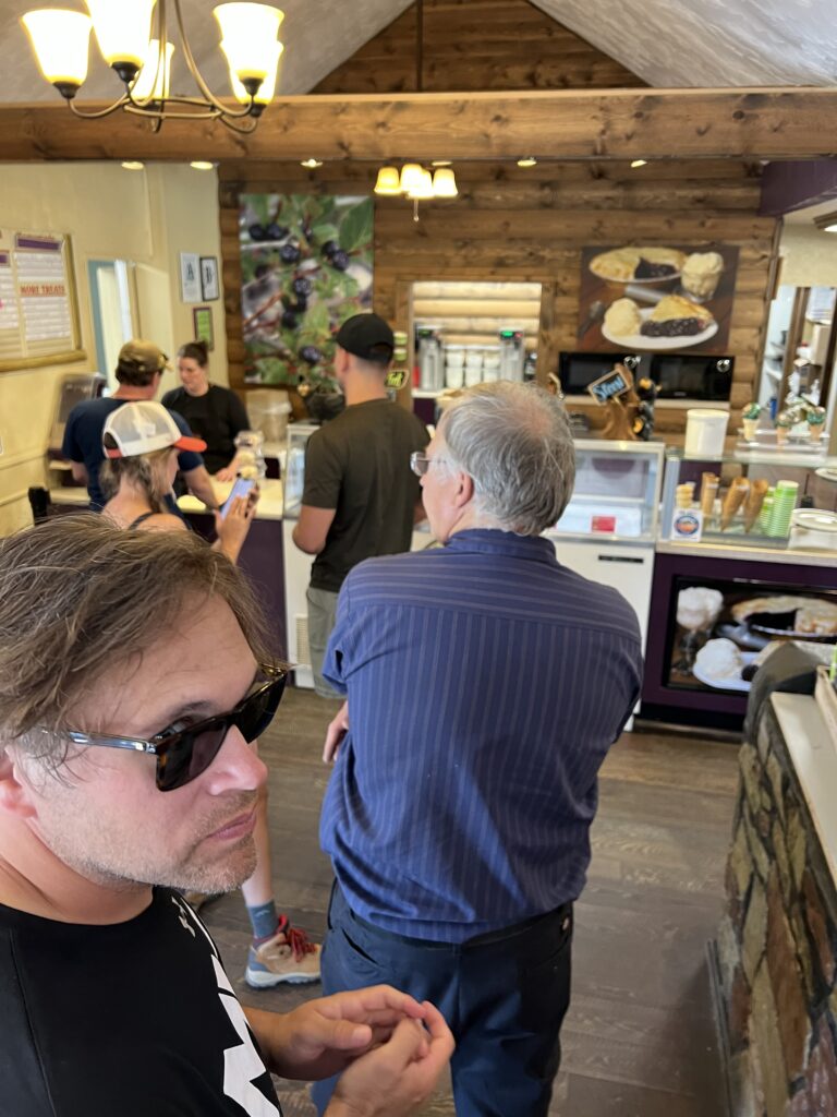 A bunch of people waiting at an ice cream counter