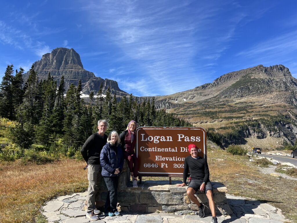 Four people at national park sign