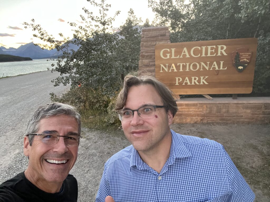 Two men in front of national park sign