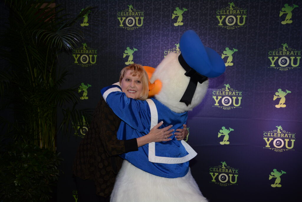 Cheryl Noel, Disney Executive hugging Donald Duck