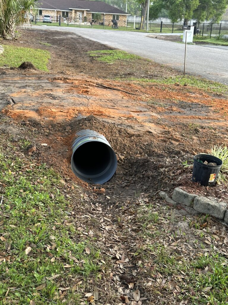 Homeowner driveway drainage pipe