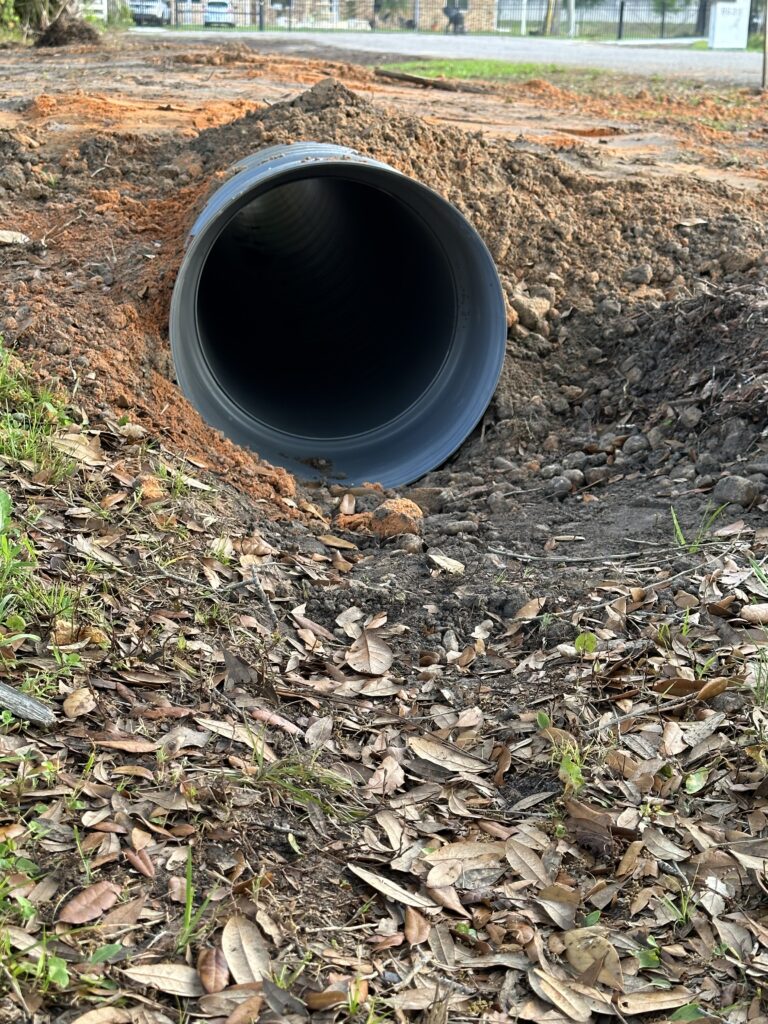 Homeowner driveway drainage pipe