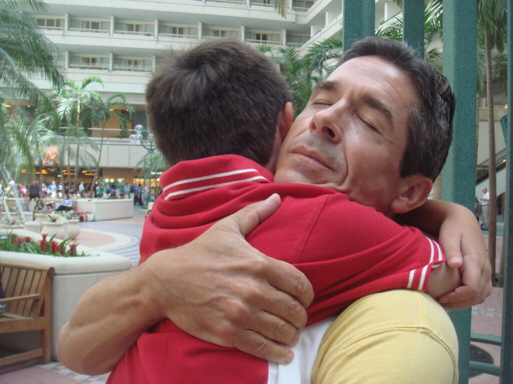 father and young son hugging at airport