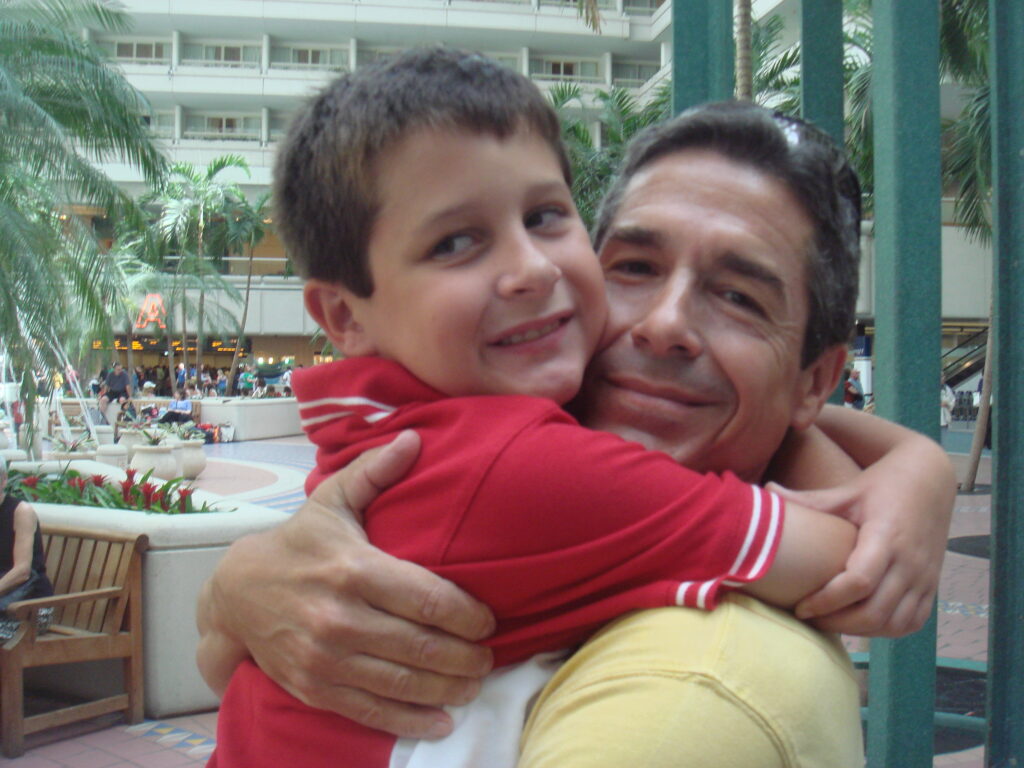 father and young son hugging at airport