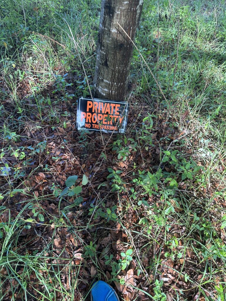 Private property sign at base of tree