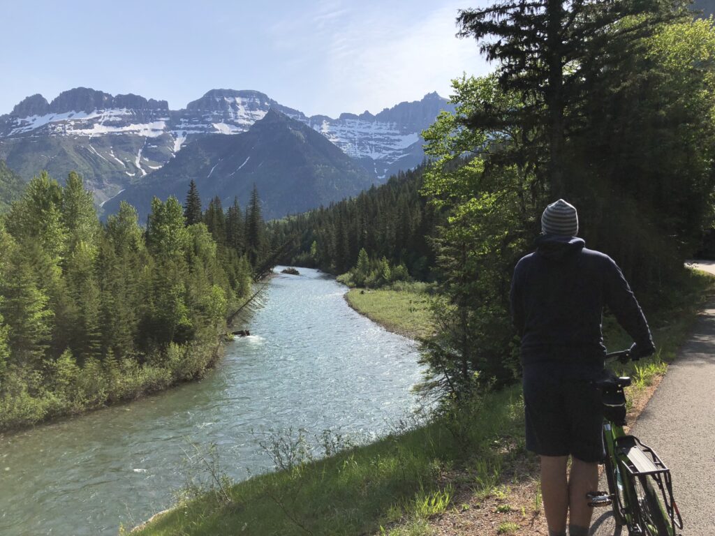 Person with a bicycle in the mountains