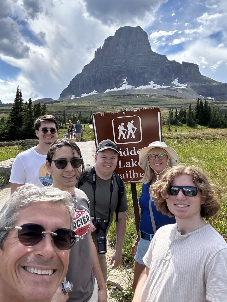 Family posing by National Park sign