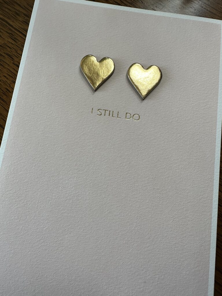 White greeting card with two gold hearts