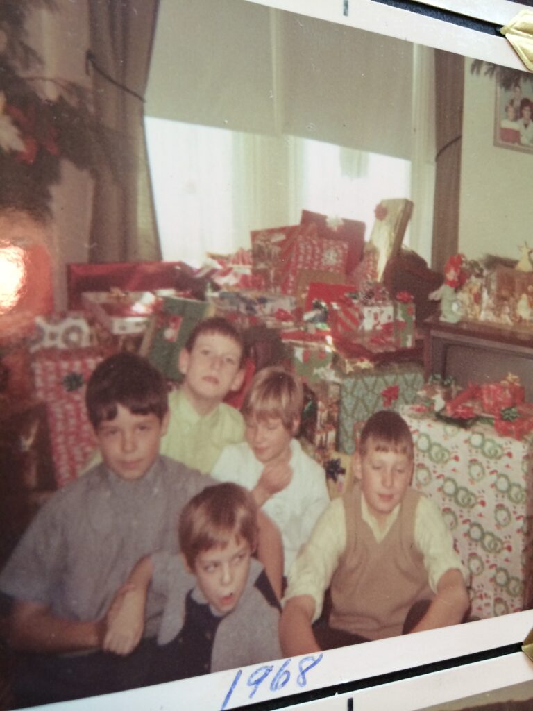 A 1960s photo of five cousins in front of a pile of Christmas presents