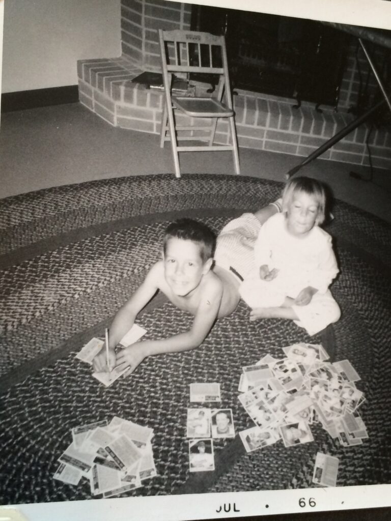 black and white 1966 photo of two kids on the floor