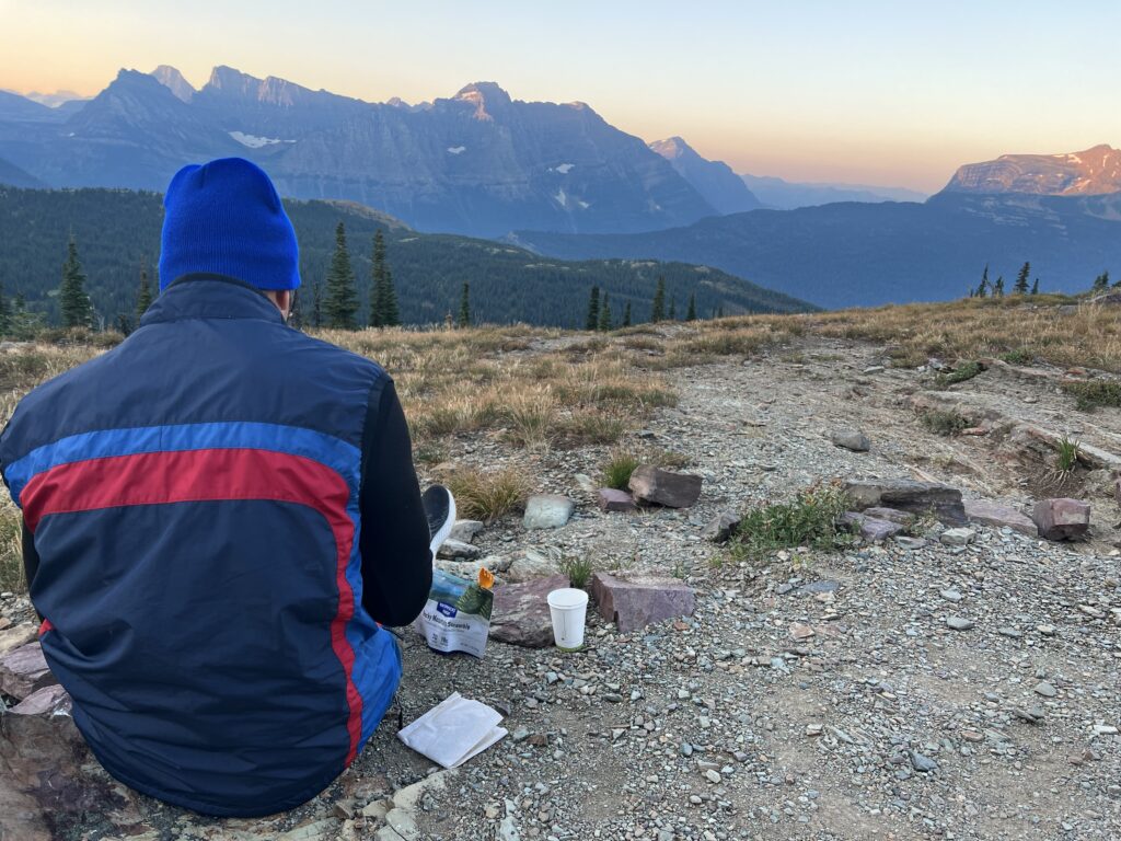 Man sitting on ground in mountains