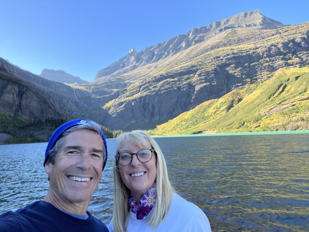 Couple posing by mountain lake