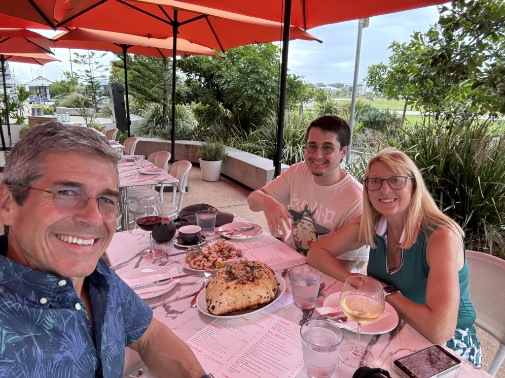 three people at an outdoor dinner table