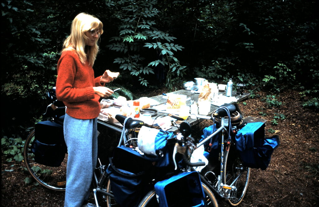 Woman standing next to touring bicycle