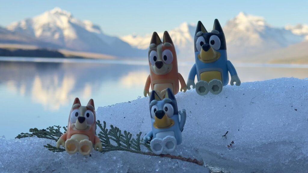 Bluey toy figurines at mountain lake