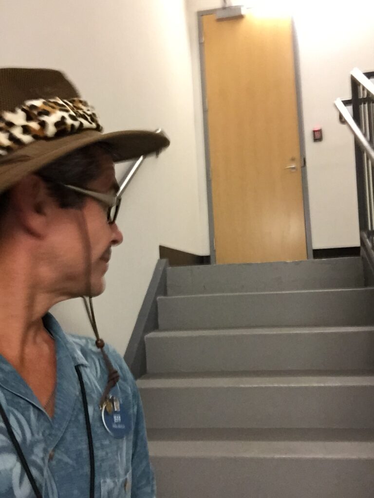 Man in hat in stairwell