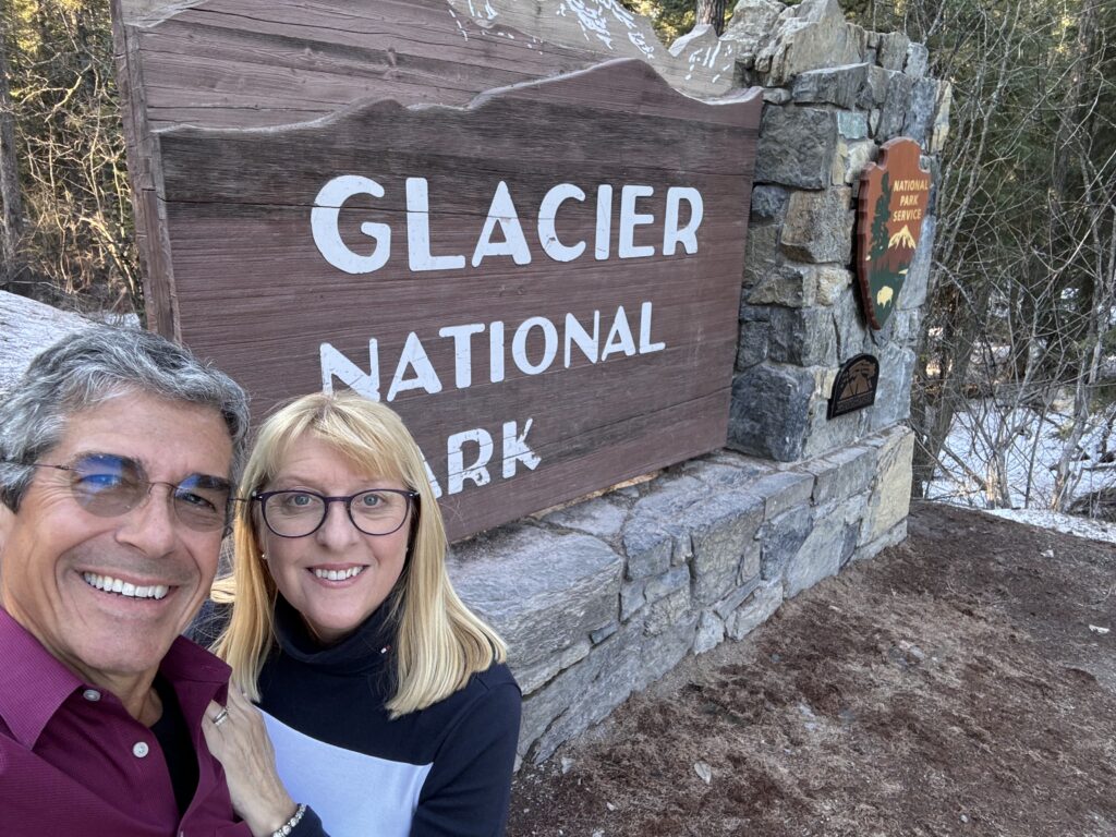 two people at National Park sign