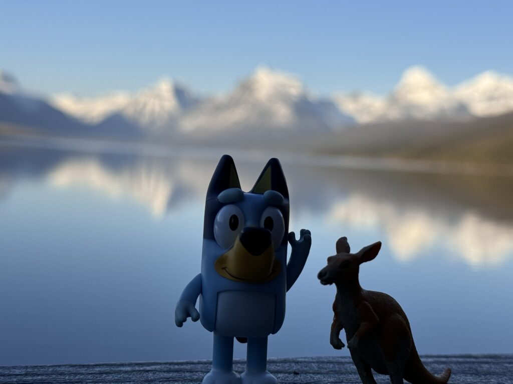 toy figurines by mountain lake