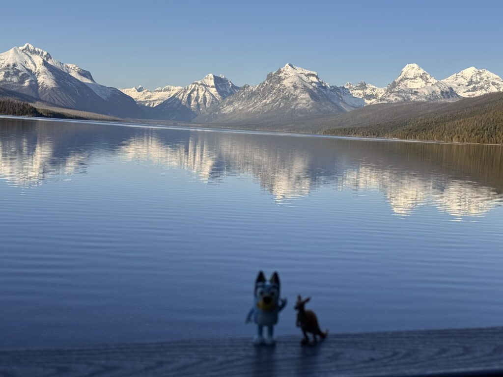 toy figurines by mountain lake