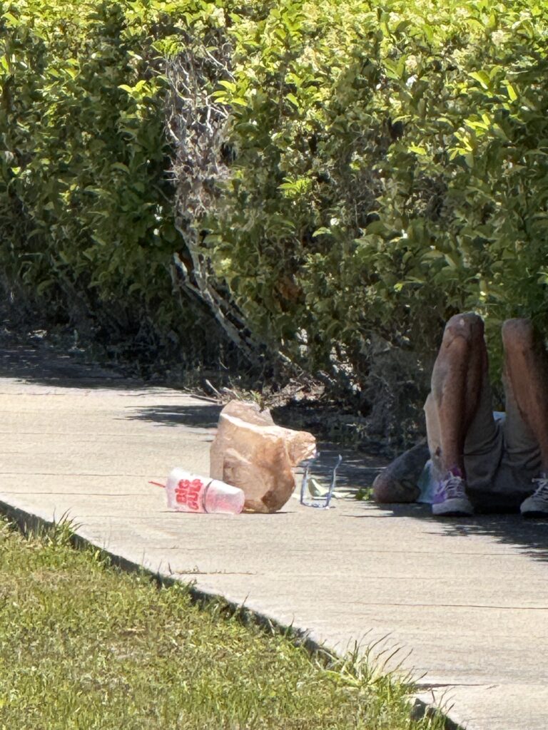 Person sleeping on sidewalk