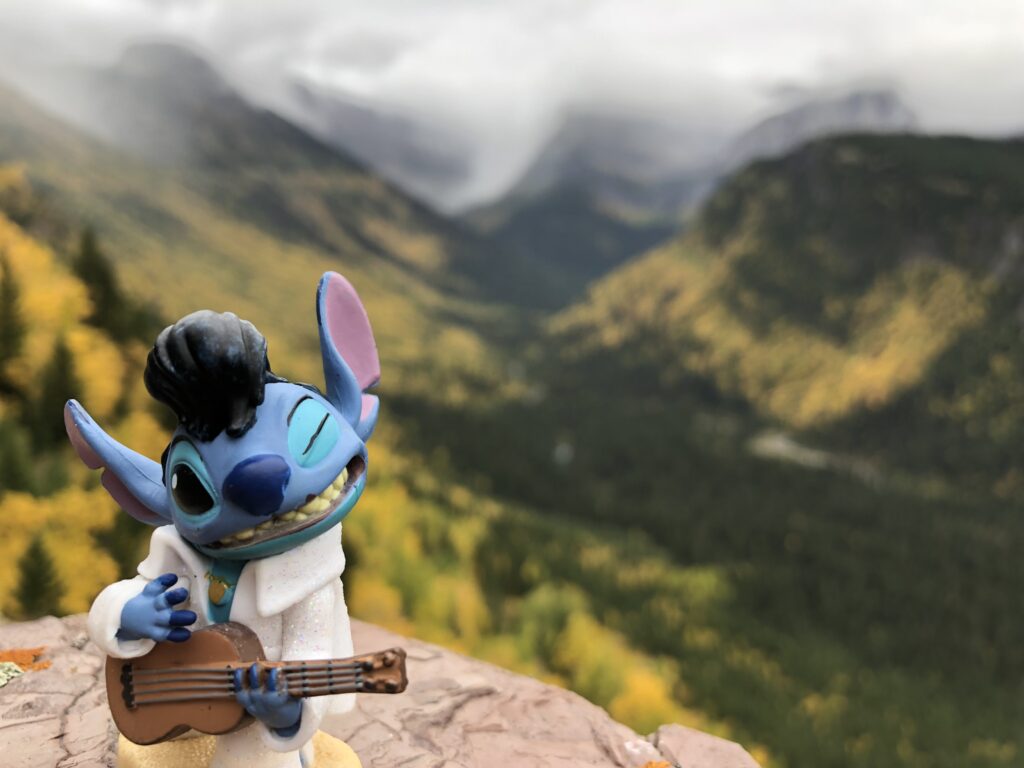 toy Stitch figurine in mountains