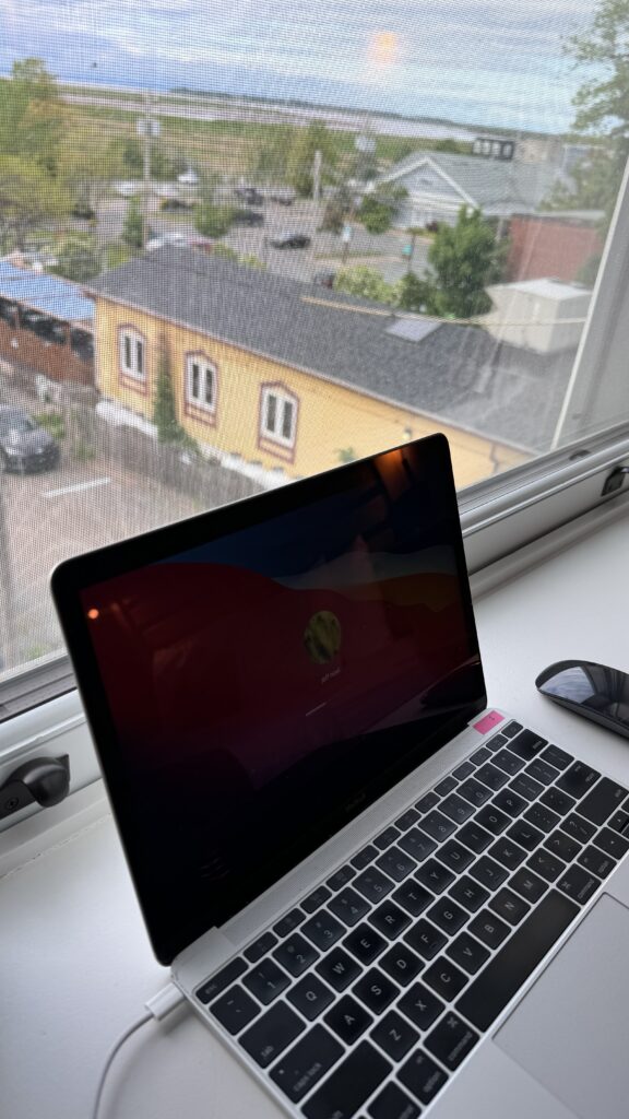 Macbook on a windowsill