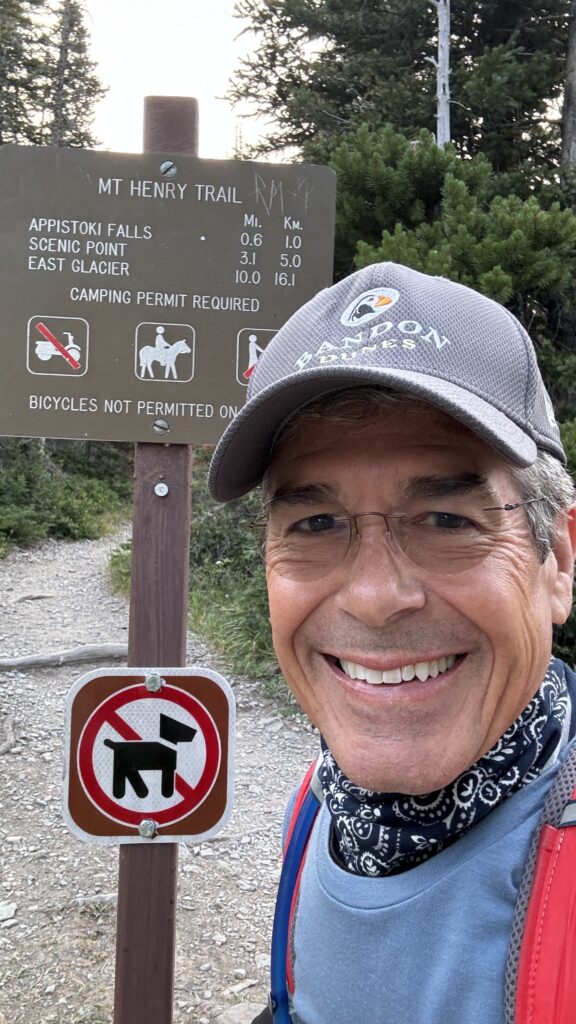 Person at trailhead sign