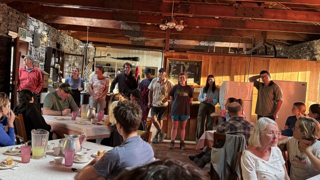 Room full of people in a mountain chalet dining hall