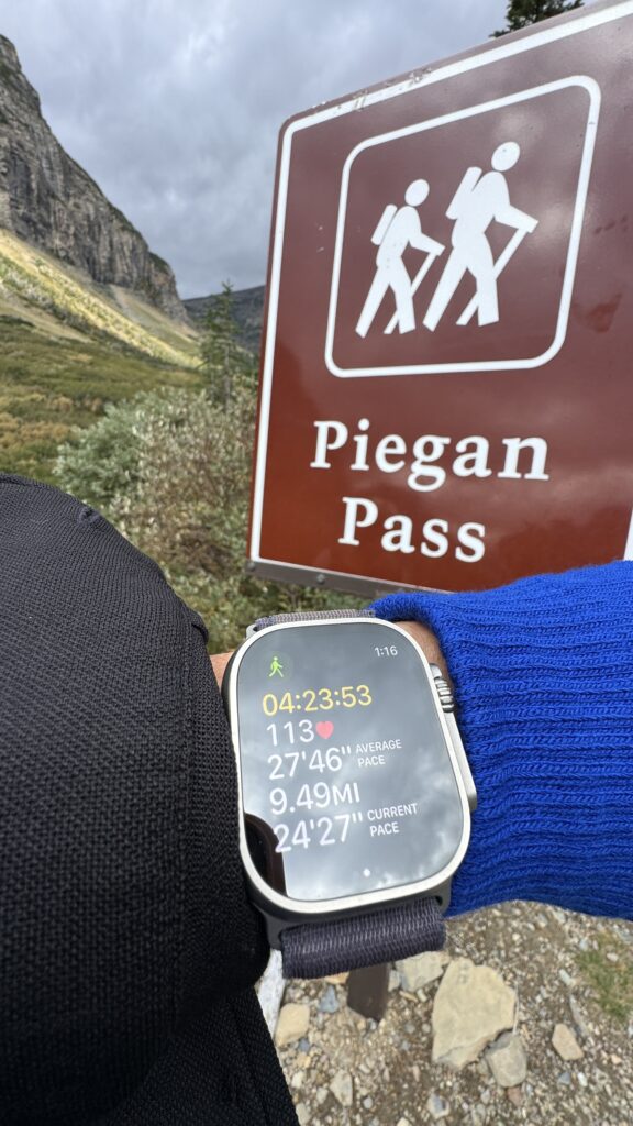 Apple Watch fitness app at trailhead sign