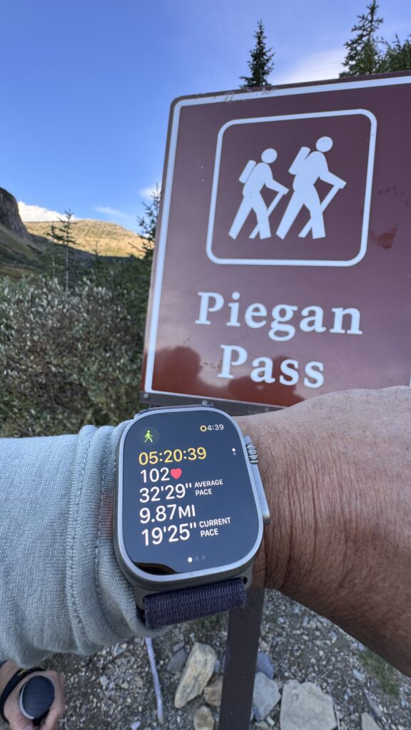 Apple Watch fitness app next to trailhead sign