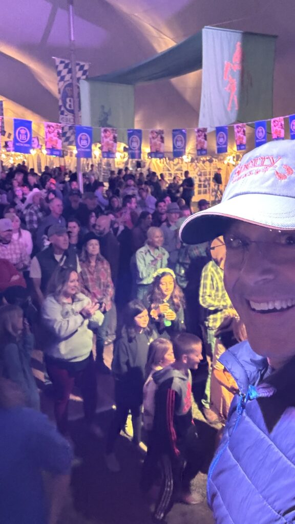 Man on a stage selfie and audience