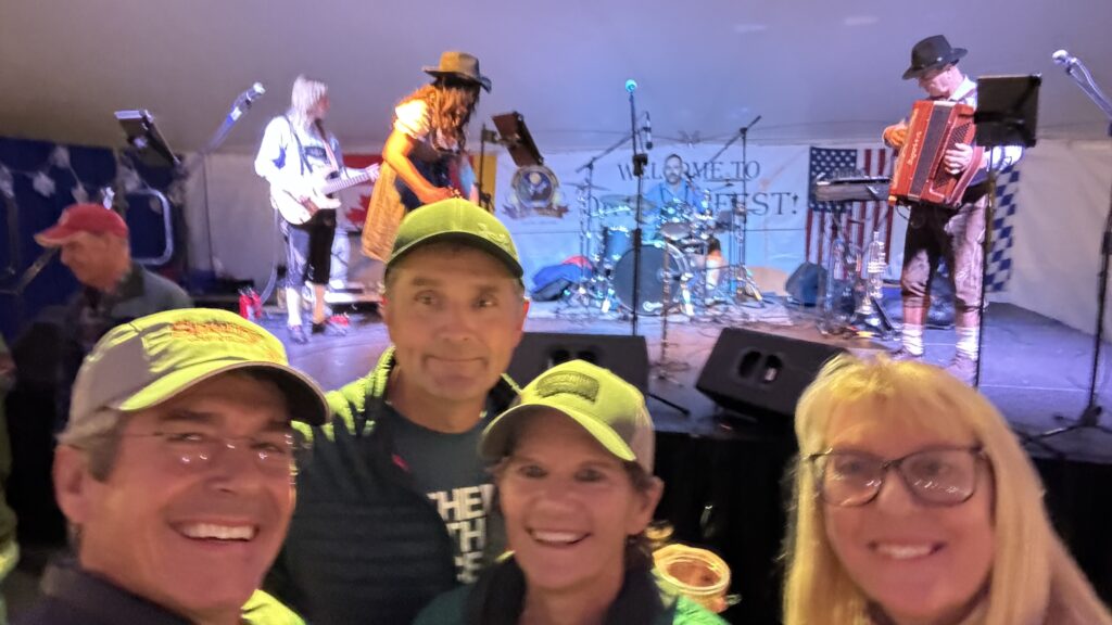 Four people in front of a small stage