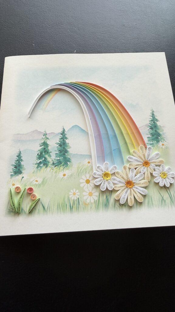 Card with rainbow and daisies design