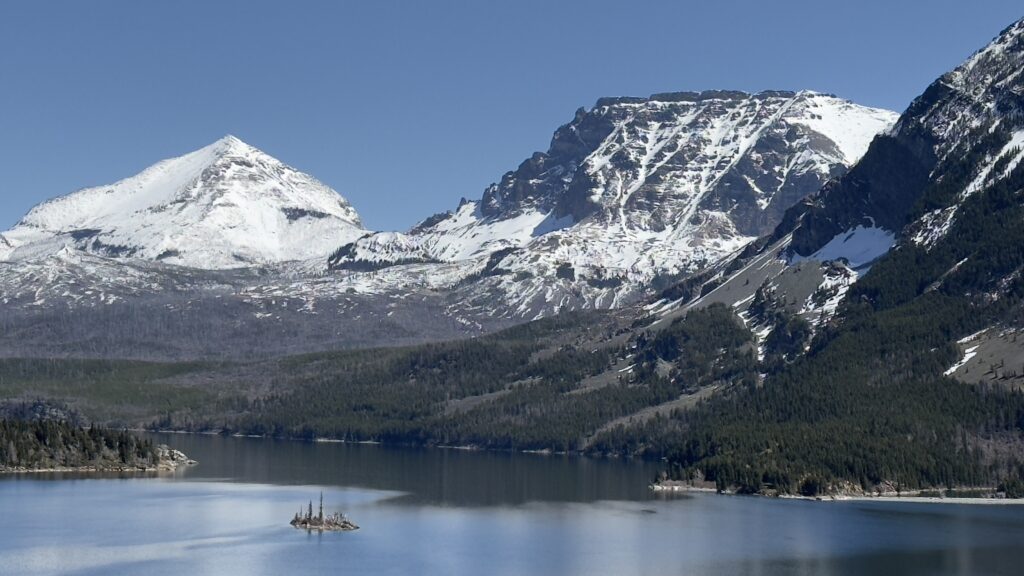 snowy mountains and lake in Glacier National Park